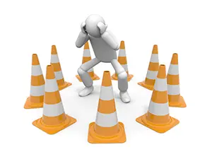 カラーコーンに囲まれて頭を抱えパニックになっている白い3Dの人物