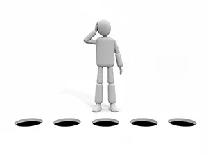 3D man looking confused and holding head in front of holes in the ground